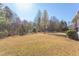 Open backyard featuring a playset and soccer goal, with mature trees, great for outdoor activities and recreation at 3708 Tansley St, Wake Forest, NC 27587
