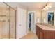 Bathroom featuring a tiled shower, dual sink vanity and access to a walk-in closet for added convenience at 3708 Tansley St, Wake Forest, NC 27587