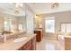 Bright bathroom with granite countertops, a soaking tub, and double vanities for convenience and luxury at 3708 Tansley St, Wake Forest, NC 27587