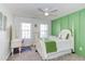 Spacious bedroom with green accent wall, white trim and furnishings, and plush carpet for a cozy feel at 3708 Tansley St, Wake Forest, NC 27587