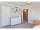 Bedroom featuring a light colored wall, carpet, and a changing table, creating a cozy and restful atmosphere at 3708 Tansley St, Wake Forest, NC 27587
