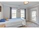 Bright bedroom with a full bed, plush carpet, and plenty of natural light from the two windows at 3708 Tansley St, Wake Forest, NC 27587