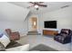 Comfortable bonus room with plush seating, mounted TV, and an opening with stairs leading down at 3708 Tansley St, Wake Forest, NC 27587