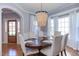 Formal dining room featuring an elegant chandelier, a dark table, and ample natural light at 3708 Tansley St, Wake Forest, NC 27587
