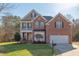 Charming two-story brick home boasts a lush green lawn and inviting curb appeal at 3708 Tansley St, Wake Forest, NC 27587