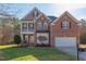 Beautiful two-story brick home with well-manicured lawn and attached two-car garage at 3708 Tansley St, Wake Forest, NC 27587