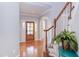 Welcoming foyer with hardwood floors, a wooden staircase, and a decorative entry door at 3708 Tansley St, Wake Forest, NC 27587