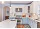 A gourmet kitchen boasts modern white cabinets, stainless appliances, and a center island with a sink at 3708 Tansley St, Wake Forest, NC 27587