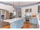 Kitchen showcases stainless steel appliances, island with sink, and lots of counter and cabinet space at 3708 Tansley St, Wake Forest, NC 27587