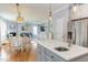 Open-concept kitchen with breakfast nook, stainless steel appliances, and views to a cozy living area at 3708 Tansley St, Wake Forest, NC 27587