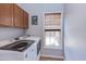 Functional laundry room featuring modern appliances, light cabinets, and a window providing natural light at 3708 Tansley St, Wake Forest, NC 27587