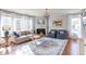 Bright living room featuring a fireplace, large windows, and comfortable seating arrangement at 3708 Tansley St, Wake Forest, NC 27587