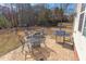 Outdoor patio area with a fire pit, grill, and dining set for entertainment at 3708 Tansley St, Wake Forest, NC 27587