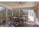 Bright screened porch featuring a dining table with seating and views of the backyard at 3708 Tansley St, Wake Forest, NC 27587