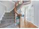 Carpeted staircase in the front entryway complemented by hardwood floors and neutral wall colors at 3708 Tansley St, Wake Forest, NC 27587