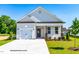 Charming single-Gathering home with attached garage, beautiful landscaping, and inviting front porch at 378 Bluejay St, Clayton, NC 27520