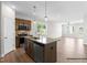 Modern kitchen boasts stainless steel appliances, sleek granite countertops, and opens into the living area at 378 Bluejay St, Clayton, NC 27520