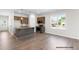 Open concept kitchen featuring granite island, stainless appliances, and wood flooring at 378 Bluejay St, Clayton, NC 27520