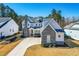 Two-story home with stone accents, three-car garage, landscaped lawn, and covered front porch set in a residential neighborhood at 3847 Stoneridge Forest Dr, Raleigh, NC 27612