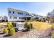 Manicured backyard featuring a backup generator, screened porch, and meticulous landscaping at 3847 Stoneridge Forest Dr, Raleigh, NC 27612