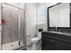 Updated bathroom features a tiled walk-in shower, modern vanity, and a large framed mirror at 3847 Stoneridge Forest Dr, Raleigh, NC 27612
