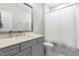 Bathroom boasting a modern vanity, large mirror, and a shower with patterned shower curtain at 3847 Stoneridge Forest Dr, Raleigh, NC 27612