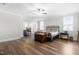 Spacious bedroom with hardwood floors, natural light from multiple windows, and a ceiling fan at 3847 Stoneridge Forest Dr, Raleigh, NC 27612