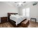 Bedroom featuring hardwood floors, natural lighting, a ceiling fan, a tufted leather bed, and matching leather bench at 3847 Stoneridge Forest Dr, Raleigh, NC 27612