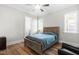 Comfortable bedroom featuring a bed, ceiling fan, and a view to an ensuite bathroom and natural light at 3847 Stoneridge Forest Dr, Raleigh, NC 27612