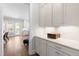 Bright butler's pantry features ample countertop space and storage, seamlessly connecting to the kitchen and dining area at 3847 Stoneridge Forest Dr, Raleigh, NC 27612