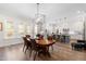 Dining room showcasing a light fixture with an open view to the modern kitchen at 3847 Stoneridge Forest Dr, Raleigh, NC 27612