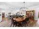 Open dining room area featuring stylish lighting and views of the modern kitchen at 3847 Stoneridge Forest Dr, Raleigh, NC 27612