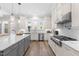 Modern kitchen with white subway tile backsplash, stainless steel appliances, and an island at 3847 Stoneridge Forest Dr, Raleigh, NC 27612
