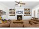 Cozy living room featuring a fireplace with built-in bookshelves, comfortable seating, and natural light at 3847 Stoneridge Forest Dr, Raleigh, NC 27612
