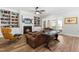 Inviting living room with a cozy fireplace, built-in bookshelves, and access to the outdoors at 3847 Stoneridge Forest Dr, Raleigh, NC 27612