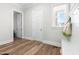 Functional mudroom with built-in bench, storage hooks, and a window for natural light, blending style with practicality at 3847 Stoneridge Forest Dr, Raleigh, NC 27612