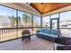 Enjoy the outdoors in this cozy screened porch with wicker furniture and scenic backyard views at 3847 Stoneridge Forest Dr, Raleigh, NC 27612