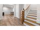Hardwood stairway featuring white risers, stained treads, and a stained wood banister; entry to living area at 3847 Stoneridge Forest Dr, Raleigh, NC 27612