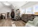 Walk-in closet with custom shelving, hanging racks, and hardwood floors with abundant storage space at 3847 Stoneridge Forest Dr, Raleigh, NC 27612