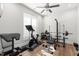 Workout area featuring hardwood floors, a ceiling fan, natural lighting, and workout equipment at 3847 Stoneridge Forest Dr, Raleigh, NC 27612
