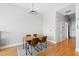 Stylish dining area featuring a modern light fixture, wood table, and leather chairs on a decorative rug at 400 W North St # 1204, Raleigh, NC 27603