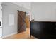 Charming entryway with a sliding barn door, cabinet storage, and hardwood floors at 400 W North St # 1204, Raleigh, NC 27603