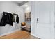 Stylish entryway with a coat rack, bench, decorative map, and light wood flooring at 400 W North St # 1204, Raleigh, NC 27603
