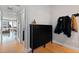 Inviting entryway with cabinet storage, coat rack, and hardwood floors, offering a glimpse of the living area at 400 W North St # 1204, Raleigh, NC 27603