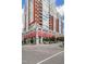 Stunning condominium building featuring red brick accents, balconies, and a retail space with red awnings at 400 W North St # 1204, Raleigh, NC 27603