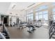 Modern fitness center with treadmills, weights, and floor to ceiling windows at 400 W North St # 1204, Raleigh, NC 27603