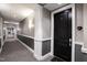 Well-lit condominium hallway with gray walls, white trim, and a black door with unit number 1204 at 400 W North St # 1204, Raleigh, NC 27603
