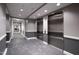 Well-lit hallway with modern decor, elevators, and tile flooring in neutral colors at 400 W North St # 1204, Raleigh, NC 27603