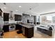 Open-concept kitchen and living area with modern appliances, granite countertops, and city views at 400 W North St # 1204, Raleigh, NC 27603