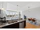 Bright, open kitchen with granite countertops and stainless steel appliances overlooking dining and living areas at 400 W North St # 1204, Raleigh, NC 27603